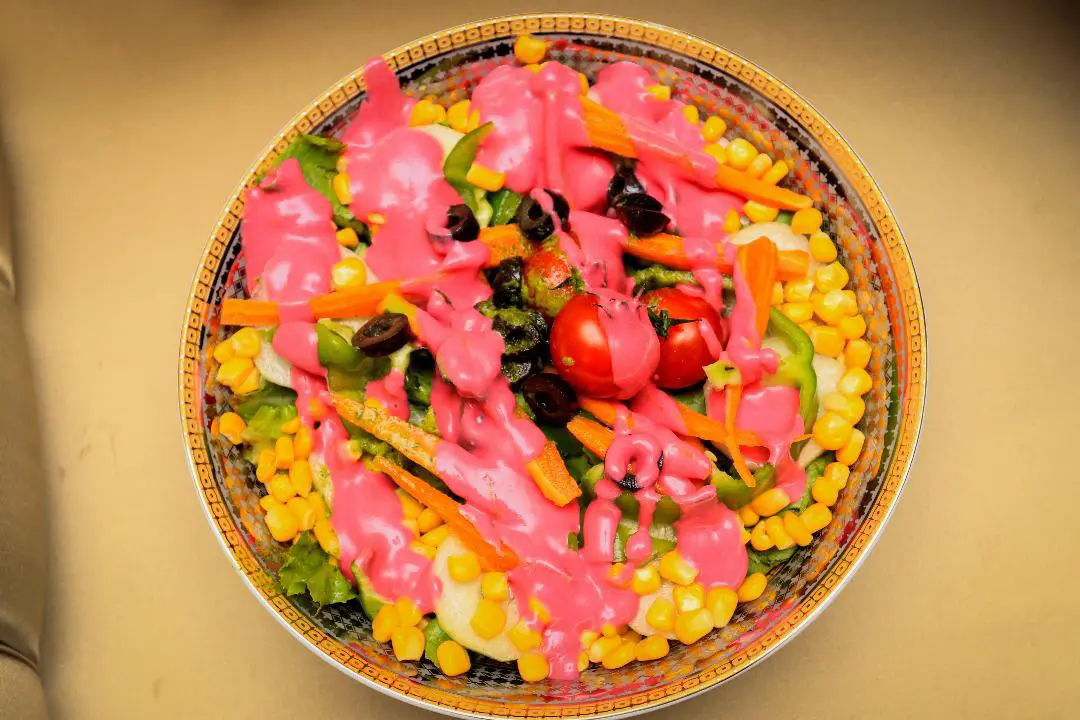 Colourful salad finished with Pink Lady beetroot dressing